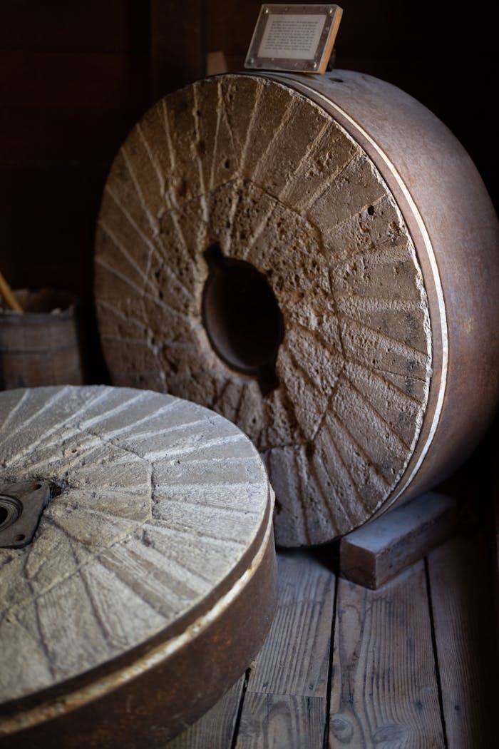 Vintage stone mill wheels used for grinding in a historic industry setting in St. Helena.